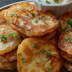 some food is sitting on a plate and ready to be eaten with sauce in the bowl