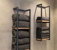 two shelves with towels hanging on them in a bathroom