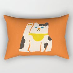 an orange pillow with a black and white cat on it