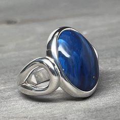 Rest assured that the photos you see in our listings are of the exact piece for sale. We take pride in listing each item individually, meaning the item you order is precisely the one you will receive. Your satisfaction is our top priority, and we strive to maintain transparency and quality in all our products. Ring Specifics Size: 6 Metal: Sterling Silver Leland Blue dimensions: 16mm x 12mm Welcome to our enchanting world of jewelry, where every piece tells a story. Feast your eyes on this exqui Collectible Blue Sapphire Ring Hallmarked, Collectible Hallmarked Blue Sapphire Ring, Collectible Blue Rings, Collectible Blue Rings With Polished Finish, Classic Handmade Blue Ring, Classic Handmade Blue Rings, Collectible Blue Sapphire Ring With Polished Finish, Blue Sapphire Ring With Polished Finish For Collectors, Blue Ring