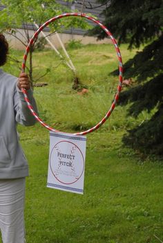 a woman holding a hoop in front of her face