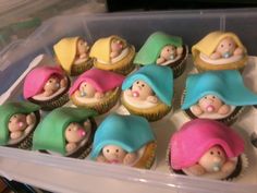 cupcakes in plastic containers with small figurines on them