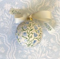 a blue and white ornament with a bow on it