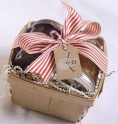 an open gift box filled with jams and cookies