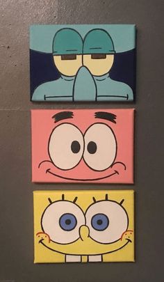 three cartoon characters painted on canvases mounted to the wall in a room with grey walls