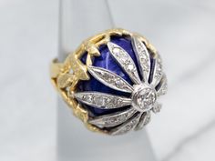 Absolutely stunning! This vintage cocktail ring features a gleaming array of diamonds throughout the floral motif on blue enamel. This is a wonderful combination of sexy and sophisticated, this vintage cocktail ring is a bold, but comfortable piece! Metal: 18K Yellow GoldGem: 27 Diamonds totaling .89 Carats, VS in Clarity, F in ColorGem Measurements: 4.0 mm, RoundMaterials: Blue EnamelRing Size: 5.5Marks: “18K” Stamped on the inside band Large Cocktail Ring, Blue Cocktail Ring, Large Gemstone Cocktail Rings, Yellow Diamond Cocktail Ring, Vintage Cocktail Ring, Filigree Pendant, Rose Gold Band, Vintage Turquoise, White Gold Band