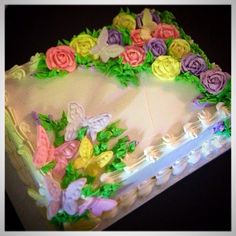 there is a cake decorated with flowers and butterflies on the top, as if it were made from icing