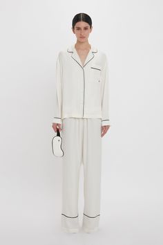 The Pyjama Sleep Set in nostalgic Ivory is an elevated sleepwear and loungewear option. An all-over VB house monogram print imbues the co-ord with its distinct personality, while the luxurious fabrication ensures comfort and ease of movement. The set comes with a tote bag and eye mask in a matching print. Victoria Beckham VB Monogram Pyjama Sleep Set In Ivory  - Size XL UK Elegant Cream Sleepwear For Home, Elegant Cream Sleepwear For Loungewear, Cream Silk Sleepwear, White Silk Long-sleeve Sleepwear, Elegant Silk Sleepwear With Relaxed Fit, White Silk Long Sleeve Sleepwear, White Silk Sleepwear For Bedtime, Luxury Silk Long Sleeve Sleepwear, Luxury Long Sleeve Silk Sleepwear