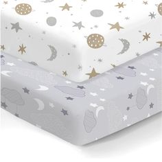 two sheets with stars and planets on them, one in grey and the other in gold