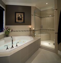 a bathroom with a large jacuzzi tub next to a walk in shower