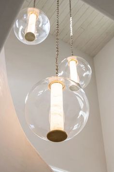 three clear glass globes hanging from the ceiling