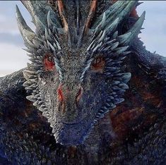 a close up of a dragon with red eyes