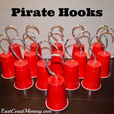 there are many red buckets that have silver handles on them, and the words pirate hooks above them