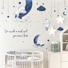 a baby's nursery room with stars, clouds and an elephant on the moon