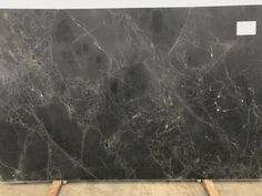 a large black marble slab in a warehouse