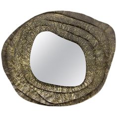 a close up of a mirror on a white background with an oval shaped object in the middle