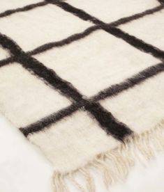 a black and white checkered rug with fringes