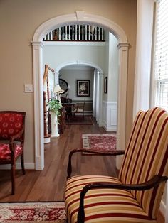 a living room filled with furniture next to a doorway