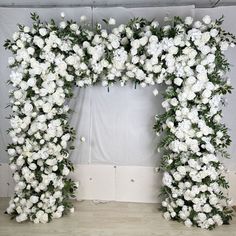 white flowers are arranged in the shape of an arch