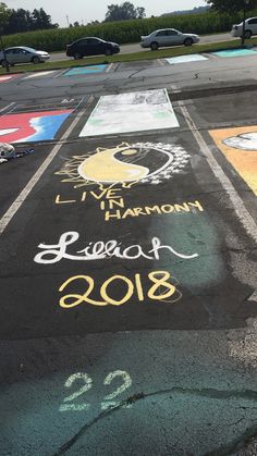 an empty parking lot with chalk drawings on it