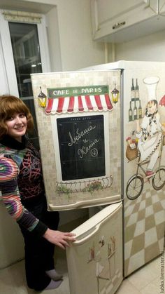 a woman standing next to two refrigerators with pictures on the front and side of them