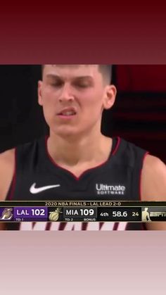 a basketball player with his eyes closed in front of a tv screen showing him on the sidelines