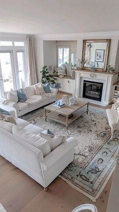 a living room filled with furniture and a fire place in the middle of a room