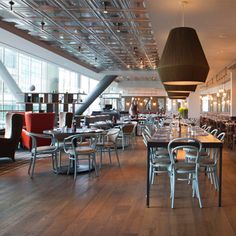 an empty restaurant with lots of tables and chairs