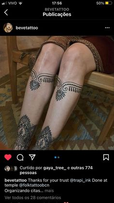 a woman with tattoos on her legs sitting in a chair