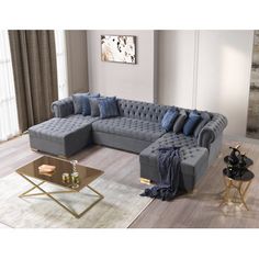 a living room with a gray couch and blue throw pillows on the back of it