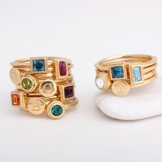 "Always wanted to be a jewelry designer? Now you can be with our DIY stackable rings. You can combine any number of initial, symbol and birthstone rings you want to create a stylish and meaningful piece of jewelry. Create a family ring with one initial and one birthstone for each member of your family! **Note: The price listed is for a set of two rings, one initial ring and one birthstone ring in 24K gold vermeil. Make the selection of which combination you want below and the price will change a Modern Stackable Initial Ring For Anniversary, Modern Gold Stackable Birthstone Rings, Modern Gold Stackable Rings With Birthstones, Modern Personalized Stackable Rings, Personalized Modern Stackable Rings, Modern Stackable Round Birthstone Ring, Gold Gemstone Stackable Rings For Birthday, Gold Rings With Bezel Setting For Birthday, Personalized Stackable Rings With May Birthstone