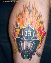 a firefighter's helmet with flames on his leg is shown in this tattoo design