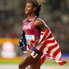 a female athlete is holding an american flag