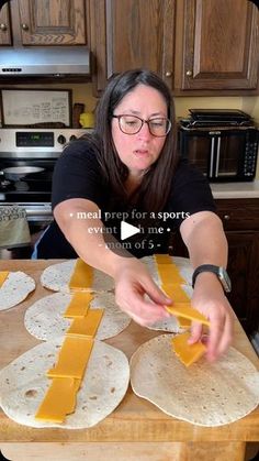 a woman is making tortillas with cheese on them