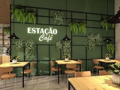 the interior of a restaurant with tables, chairs and potted plants on the wall