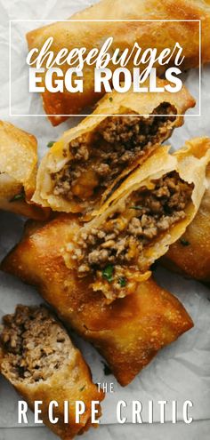 an egg roll cut in half on top of a piece of wax paper with the words cheeseburger egg rolls