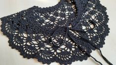 a black crocheted doily on a white surface