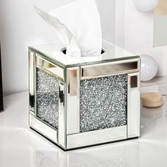 a tissue dispenser sitting on top of a white counter