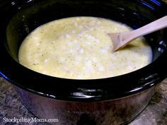 a wooden spoon in a crock pot filled with soup