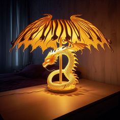 a lamp with a dragon on it sitting on a table in front of a window