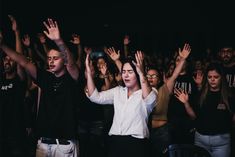 a group of people with their hands in the air