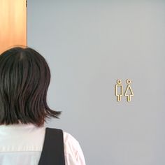 a woman standing in front of a bathroom door