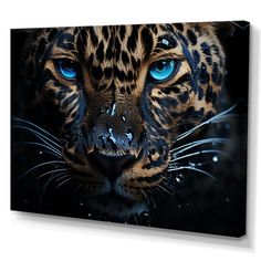 a close up of a leopard's face with blue eyes