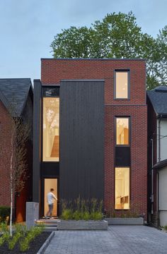 a person standing in the doorway of a brick house