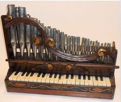 an old wooden pipe organ with many pipes on it's sides and in the case