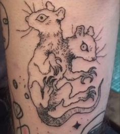 a tattoo on the leg of a person with an image of two mice in it