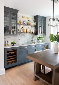 a kitchen filled with lots of counter space next to a dining room table and chairs