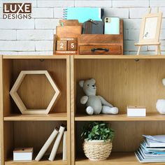 a wooden bookcase filled with lots of books next to a stuffed animal and other items