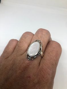 Lovely polished sterling silver has the look of Deco with a huge white Mother Of Pearl set in very detailed vintage filigree Size 7.75 We can size these with an additional $10-$20 fee for the jeweler All rings are shipped in a nice gift box. Check out our over a THOUSAND great reviews Engraving is $4 per letter and is not always perfect depending on the piece. It can take a few days if the jeweler is busy. This is payable to Paypal Judithsltd@gmail.com Vintage White Oval Cabochon Ring, White Filigree Fine Jewelry, White Fine Jewelry With Filigree Details, White Fine Jewelry With Filigree, Fine White Filigree Jewelry, White Filigree Jewelry For Formal Occasions, White Engraved Sterling Silver Rings, White Sterling Silver Rings Engraved, Engraved White Sterling Silver Rings