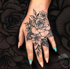 a woman's hand with flowers on it